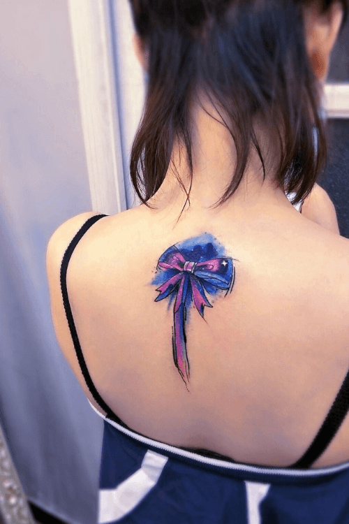 blue butterfly tattoo on back