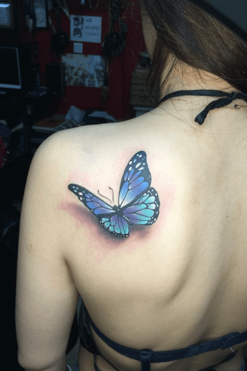 blue butterfly tattoo on shoulder