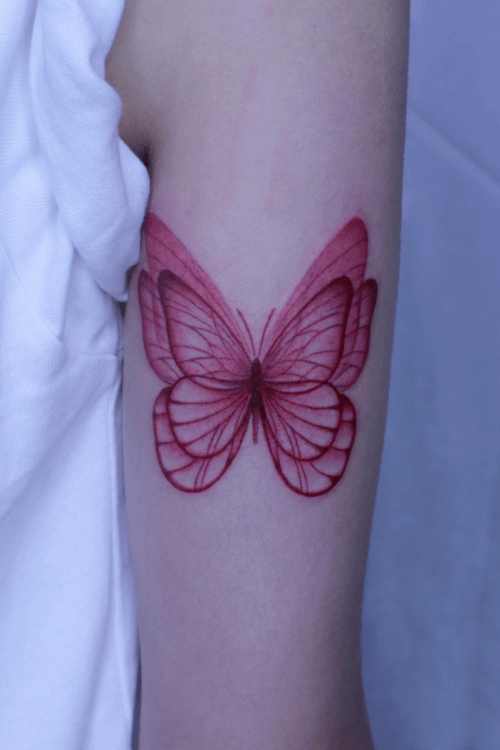 red butterfly tattoo arm